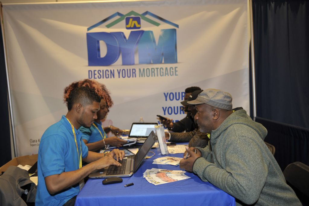 Khamar Facey (left), E-banking relationship supervisor at JN Bank and Saniah Spencer, chief marketing & product development at the JN Bank engage patrons on mortgages at the JN Group Expo in Toronto, Canada on April 27 at the Pearson Convention Center in Toronto, Canada.