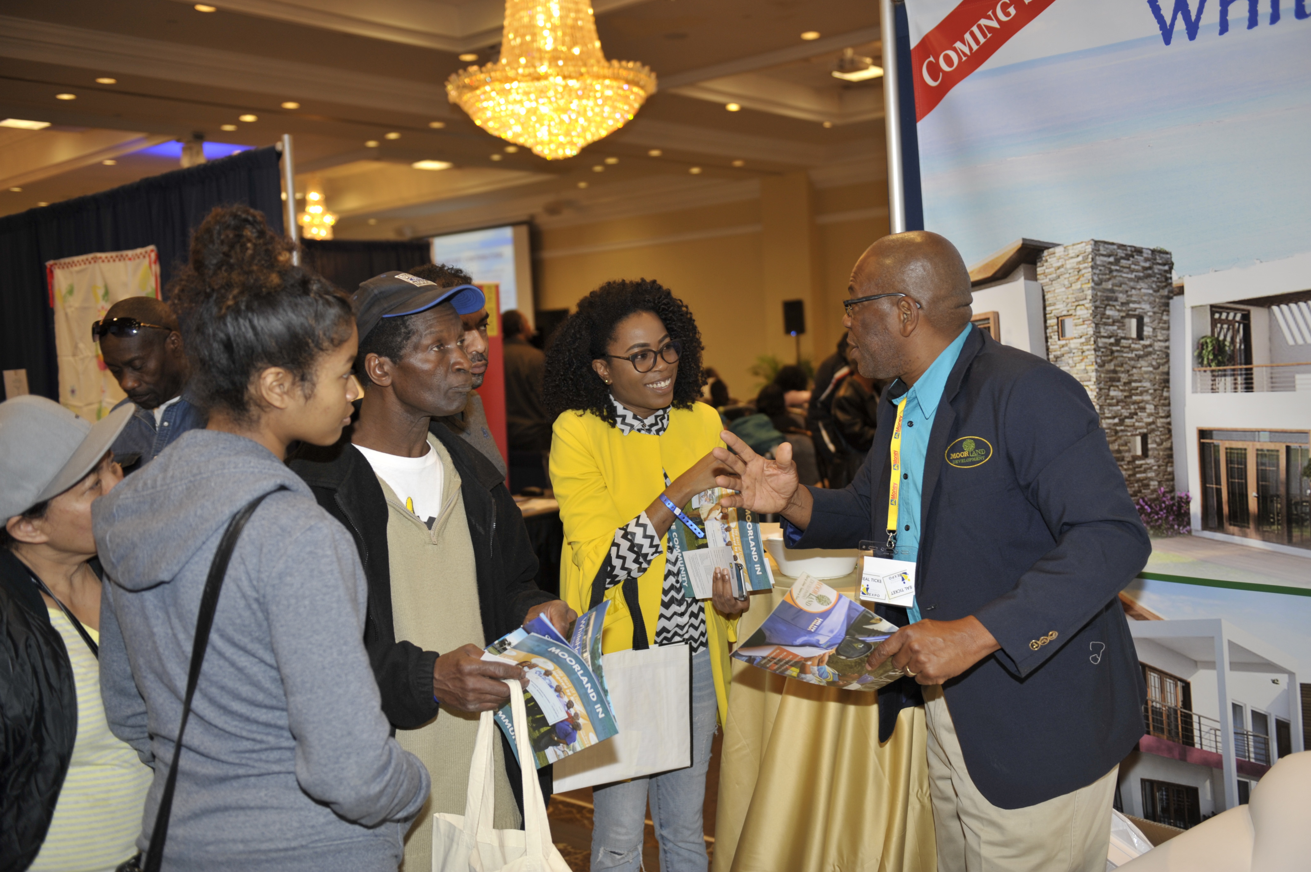 Everol Orr (right), project liaison and planning officer at Moorland Development engages patrons at the JN Group Expo in Canada on the latest developments on the market by Moorland Development.