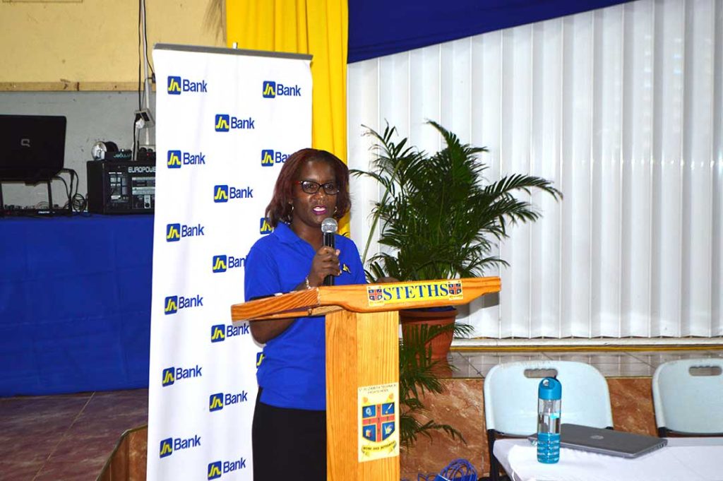 Business Relationship and Sales Manager for JN Bank, Lorna Sinclair presents to seasonal agricultural workers, also known as farm workers during a financial literacy programme at the St. Elizabeth High School on April 10.