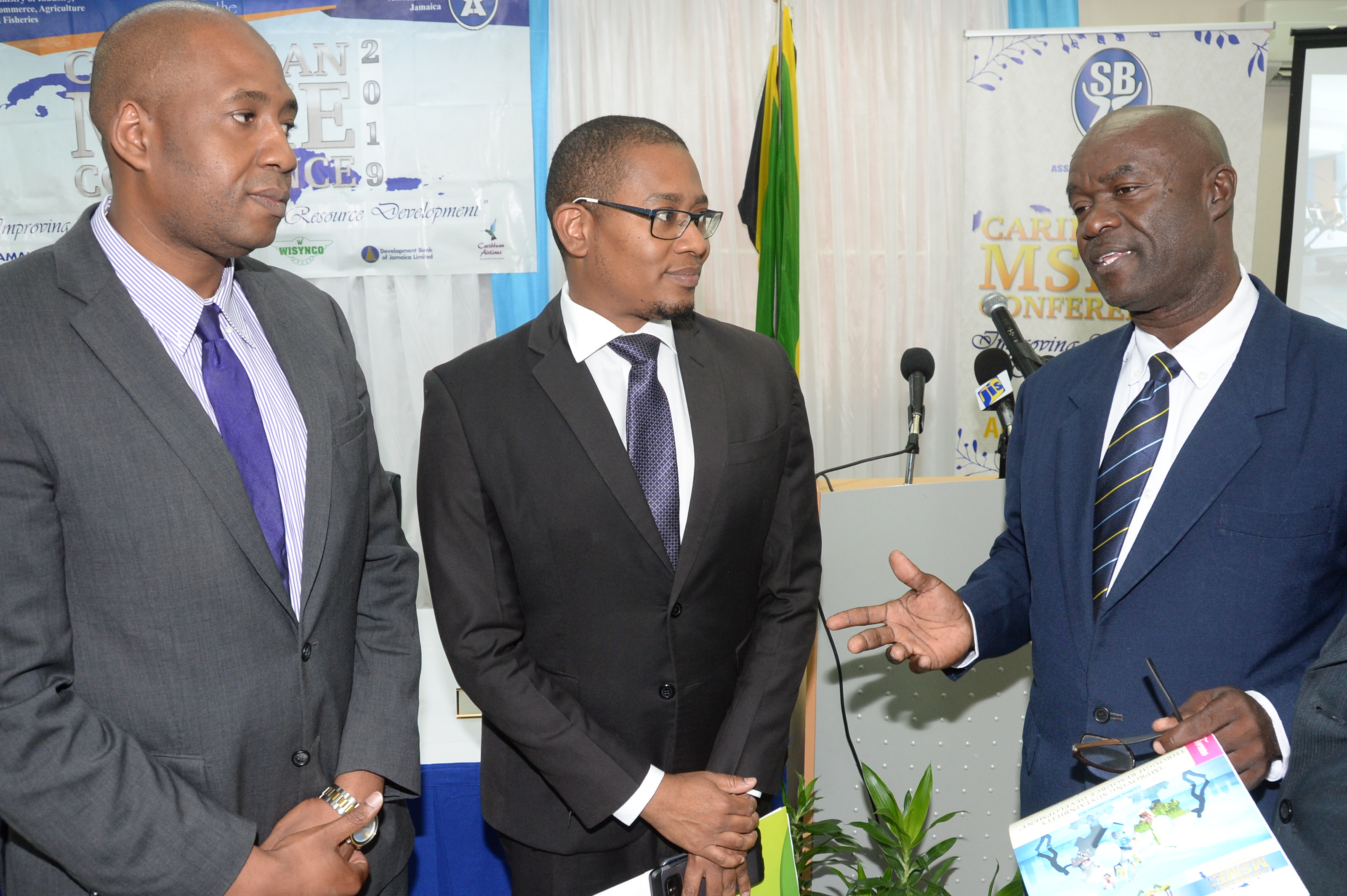 Hugh Johnson (right), president of the Small Business Association of Jamaica, makes a point to Ryan Parkes, chief of business banking at JN Bank and Floyd Green, minister of state in the Ministry of Industry, Commerce, Agriculture and Fisheries during the launch of the MSME Conference 2019 last Wednesday at the ministry’s office in New Kingston.