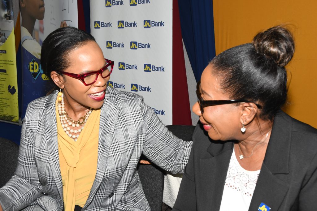 Sandra Jones (right), Manager for Public Sector Engagement at JN Bank, shares a light moment with Dr Kasan Troupe, Permanent Secretary in the Ministry of Education and Youth