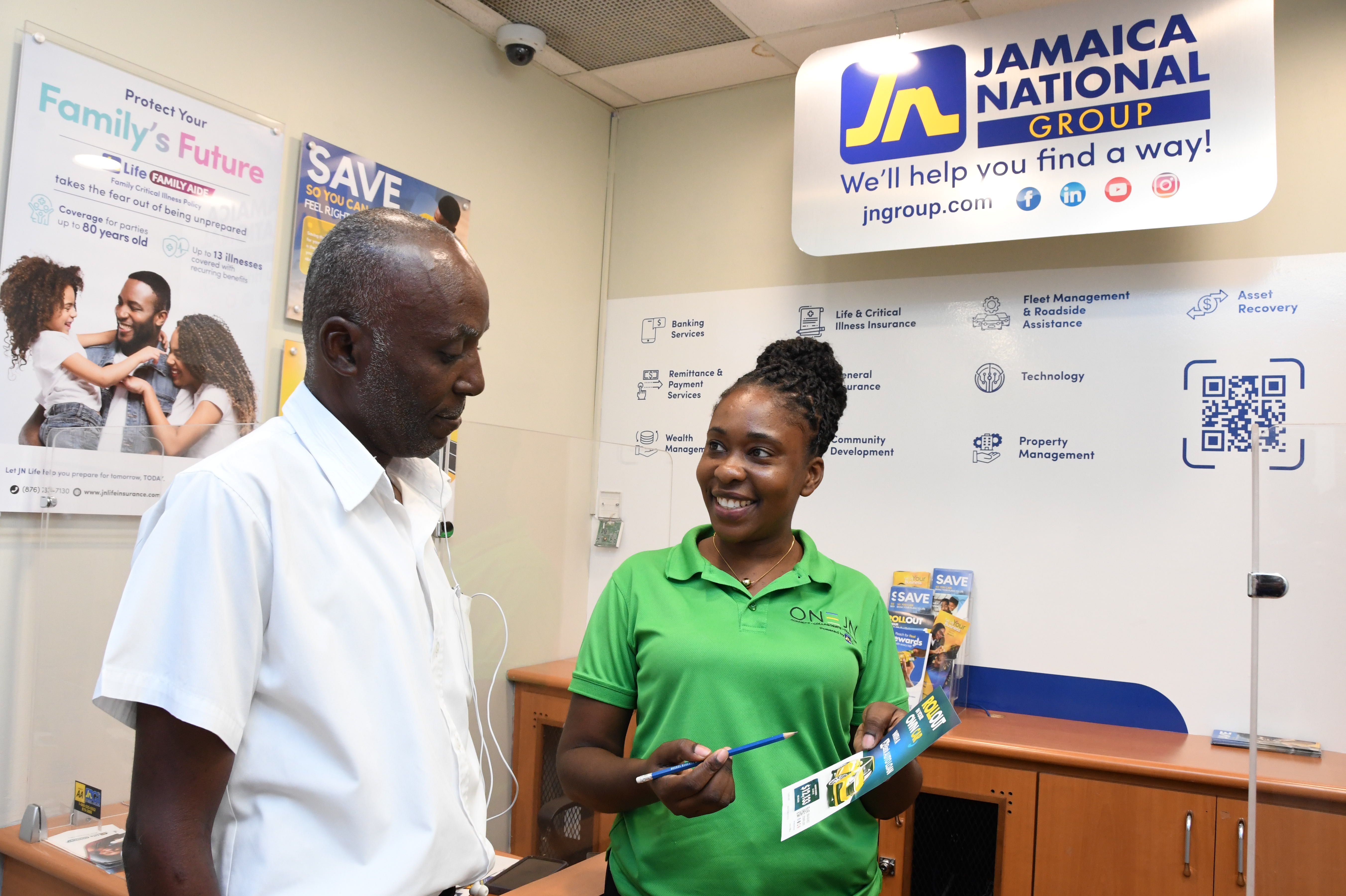 Stacy-Ann Brown McLeish (right), JN Group sales representative, provides a shopper at the MegaMart Waterloo Road branch in St Andrew, with information on a JN Bank auto loan.