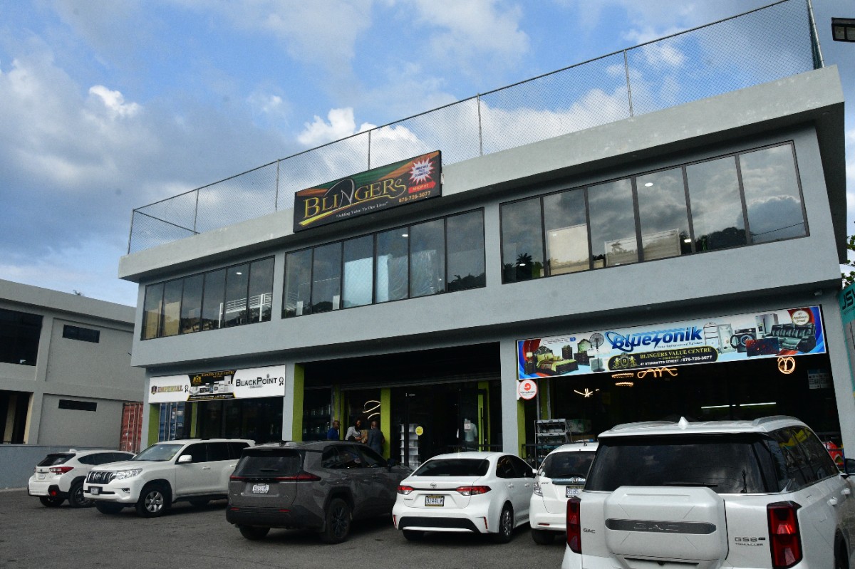 Two-story gray commercial building with large windows and a parking lot full of cars, signage for Blingers on the top floor.”]> >? Wait formatting. Need proper JSON array. Let's provide multiple items without stray quotes. Let's craft correctly.> Hmm. I'll output with array of strings. Ensure no stray curly. Let's produce. > Not include debug. Let's finalize. > Sorry. Begin: <