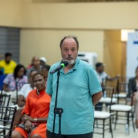 Adam Albanowicz, a member of the JN Bank Ocho Rios Branch, asks a question after the presentations.